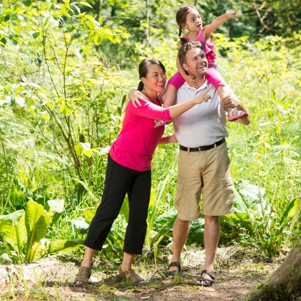 A family walking through a wooded trail in Mount Washington, OH while Hall-Mark Premier Cleaning cleans their home.